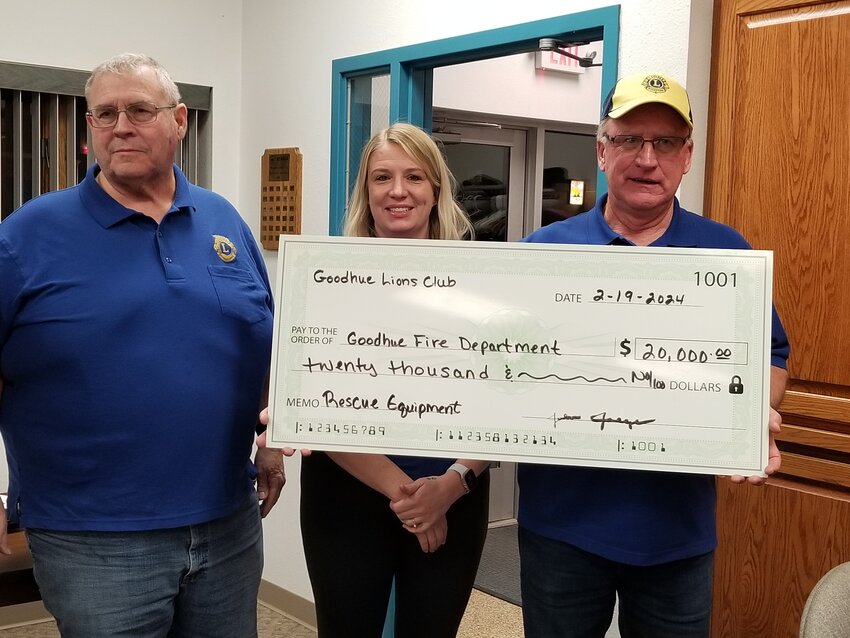 Lions, Kerry Bien, Sarah Bien, and John Jaeger present an oversized check representing the $20,000.00 charitable gambling fund donation the Goodhue Firemen's Relief Association will use for needed equipment upgrades.