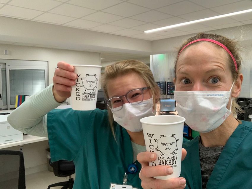 Miranda Van Dingstee, an EMT/patient-care technician, and Kate Garrette, an RN at Nantucket Cottage Hospital, with coffee from Wicked Island Bakery delivered through the Feed the Front Line program.