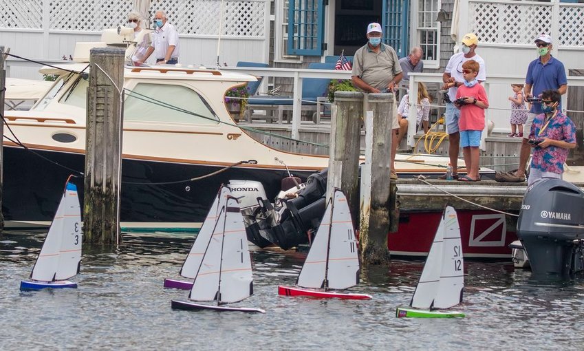 Skippers pilot their craft from the dock on Old North Wharf in Friday's radio-controlled model-boat regatta, a new addition to Nantucket Community Sailing's annual Race Week this year.