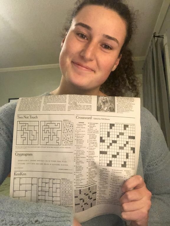 Nantucket High School graduate Luci Bresette with a copy of the New York Times crossword puzzle she helped create.