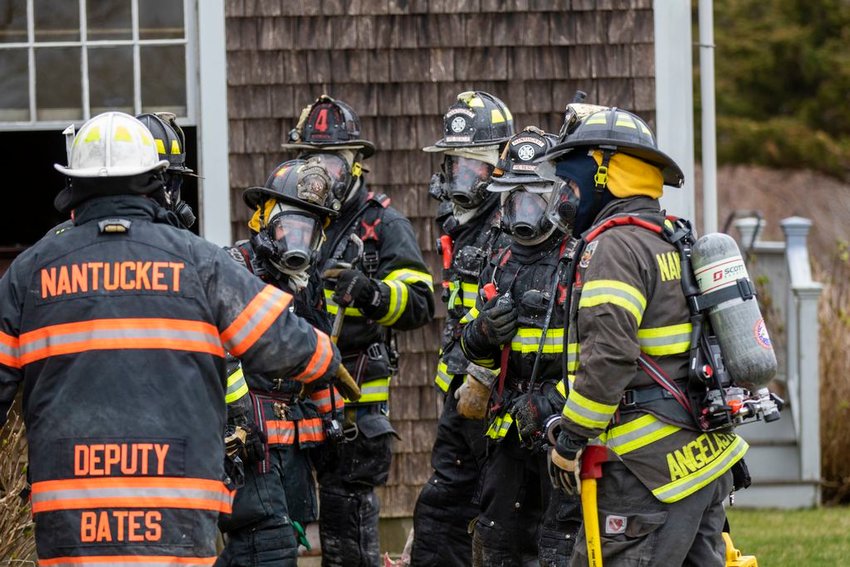 Nantucket firefighters outside a Squam Road home where fire broke out in the kitchen Saturday morning.