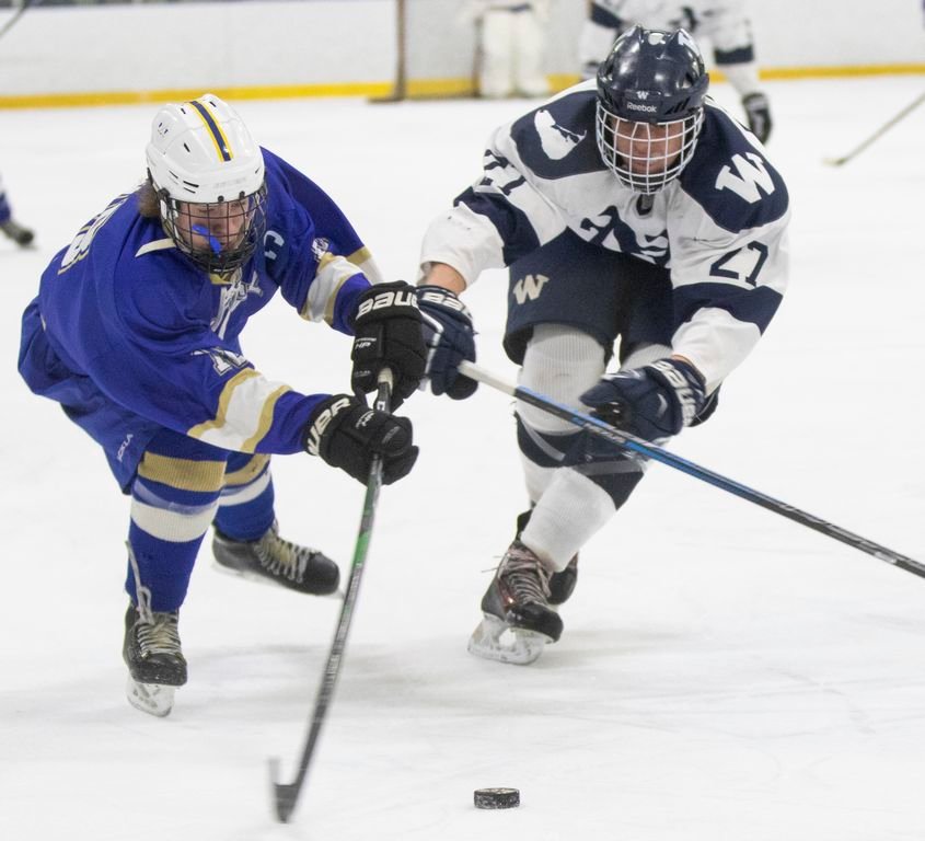 Defenseman Alex Freeman, right, reaches to break up a shot in the Whalers' 6-2 loss to Norwell Saturday.