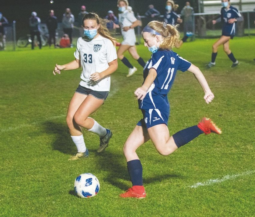 Quinn LeBrecht brings the ball upfield against Maddie Iller in the girls' soccer team's intramural homecoming game.