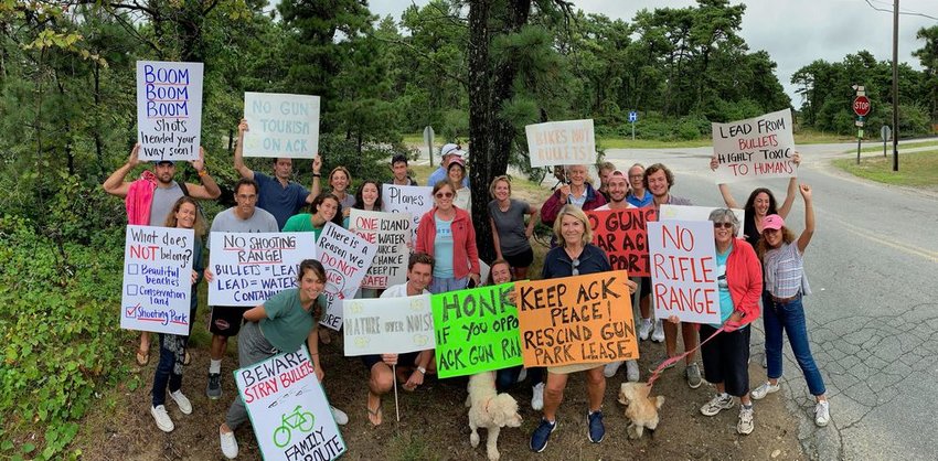 Protesters, most of them seasonal residents with property on the south shore, show their displeasure with the Nantucket Hunting Association's proposed shooting range near Nantucket Memorial Airport that has been in the works for more than a decade.