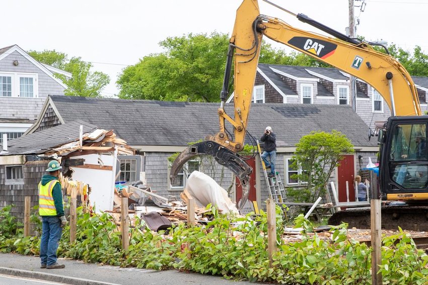 The last of six Nantucket Island School of Design and the Arts cottages to be demolished at the corner of Washington and Francis Streets is knocked down Wednesday.