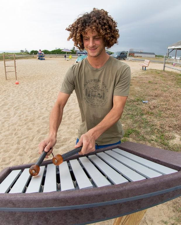 Musician Kelly Emery shows how easy it is to play the xylophone he built and installed at the Tom Nevers Field playground.