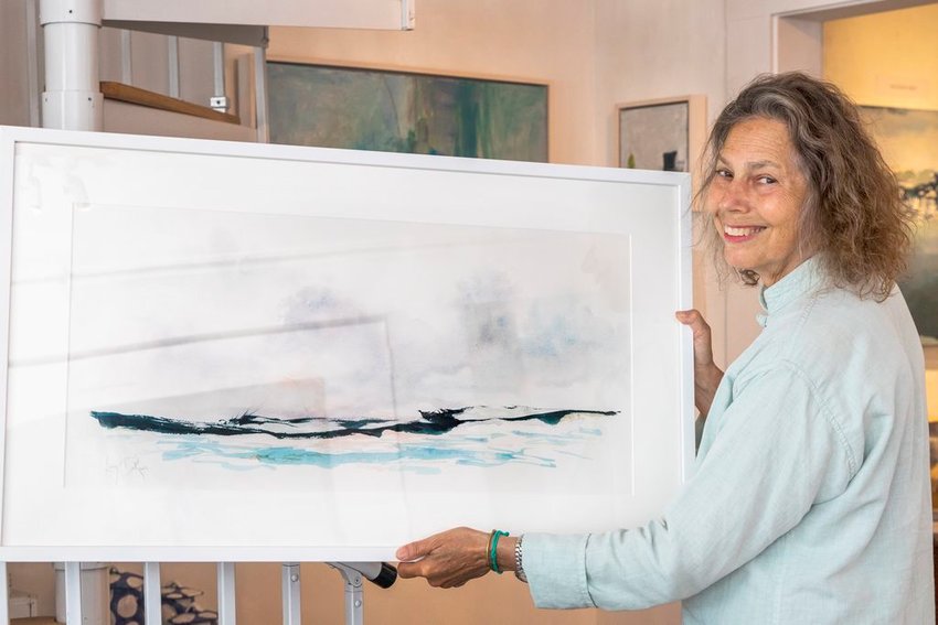 Artist MJ Levy Dickson with a recently-framed piece for her upcoming show at Robert Foster Fine Art.