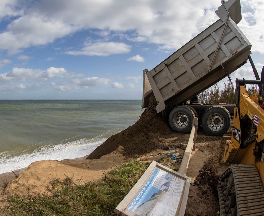 Sand is dumped over the side of the Sconset Bluff to replenish an erosion-control project on the beach below.