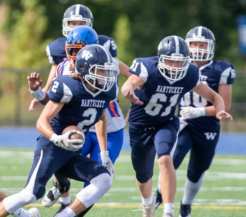 Victor Gamberoni (2) cuts upfield in Nantucket's 27-8 win over Holbrook-Avon last September as Cam Willett (61) follows the play. Gamberoni will continue his football career at Div. 3 St. Lawrence University this fall, and Willett will take the field for Div. 3 Massachusetts Maritime Academy.