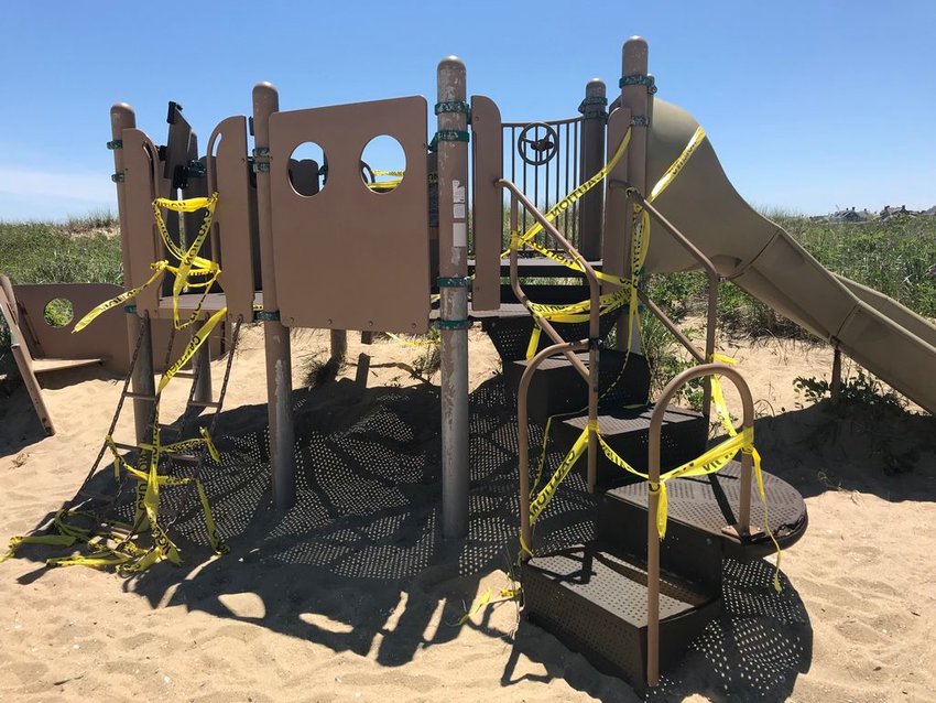 Caution tape was wrapped around this damaged playground equipment at Jetties Beach until it was eventually removed.