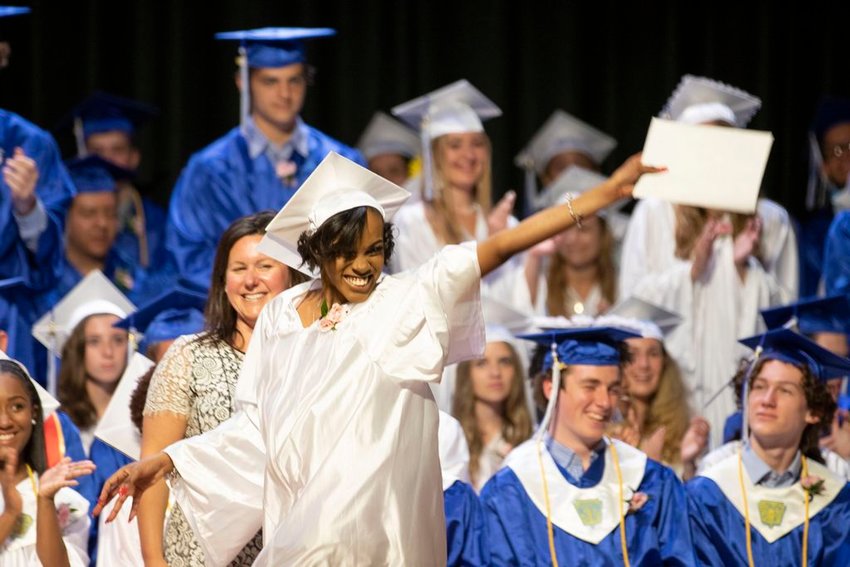 Tahirah Newman, headed to Johnson &amp;amp; Wales in the fall, waves her diploma proudly in front of School Committee chairwoman Jenn Iller during Nantucket High School graduation Saturday afternoon in the Mary P. Walker Auditorium.