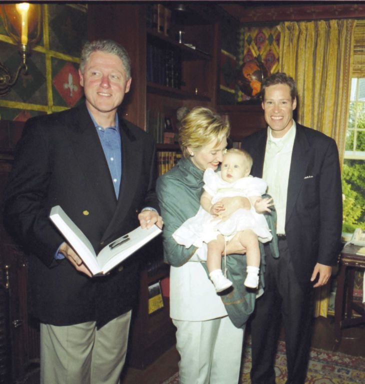 President Bill Clinton and first lady Hilary Rodham Clinton in 1999 at Bob Matthews' Cliff Road home during an American Ireland Fund event. The first lady holds Matthews' baby daughter, while he looks on with a big grin.
