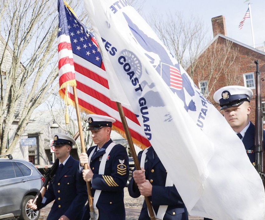 Flag-bearers from U.S. Coast Guard Station Brant Point make their way up Main Street Monday on their way to the Federal Street Town &amp;amp; County Building for Nantucket's annual Veterans Day observance.