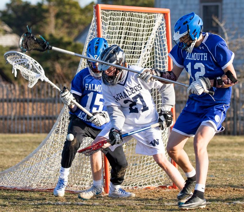 Sam O'Keefe battles for the ball in front of the Falmouth Academy net last Thursday in Nantucket's 16-2 seasonopening win over the Mariners. The Whalers, 3-0 on the season, have yet to be truly tested.