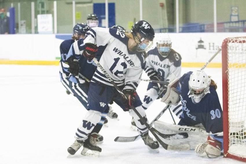 Evelyn Fey battles for the puck in the crease against Sandwich.