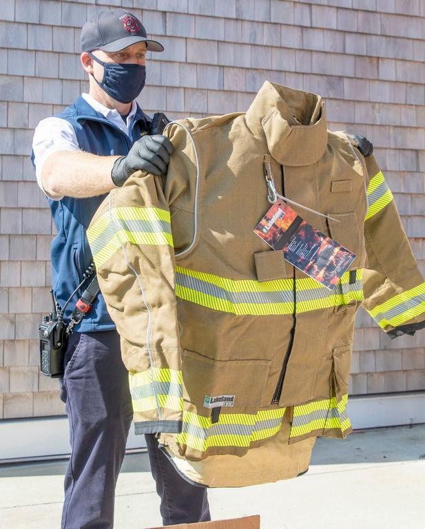 Nantucket Deputy Fire Chief Sean Mitchell reviewing a sample of new turnout gear.