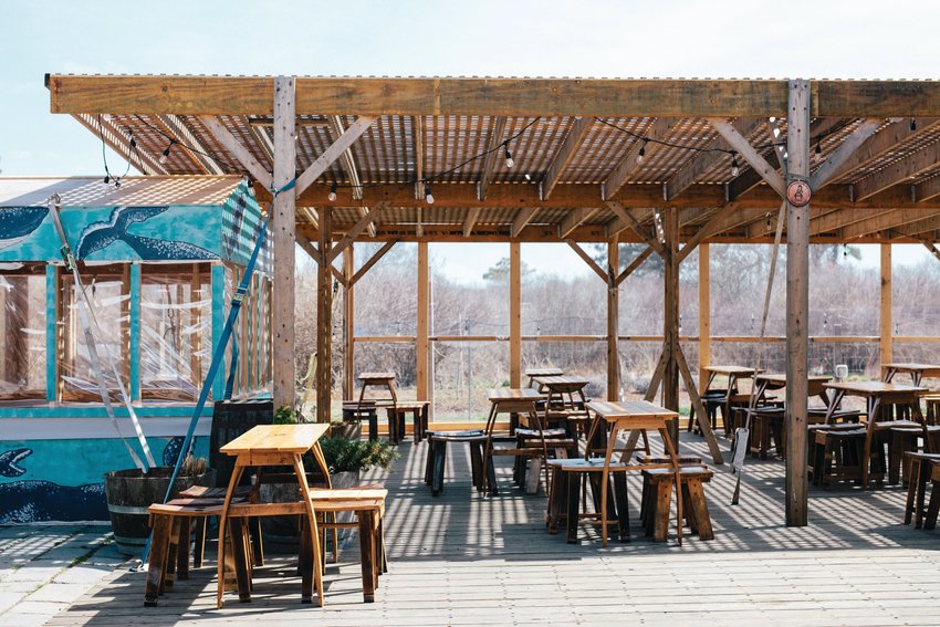 Cisco Brewers reopened last Thursday with tables spaced six feet apart, and enclosed wooden huts for people to drink in.