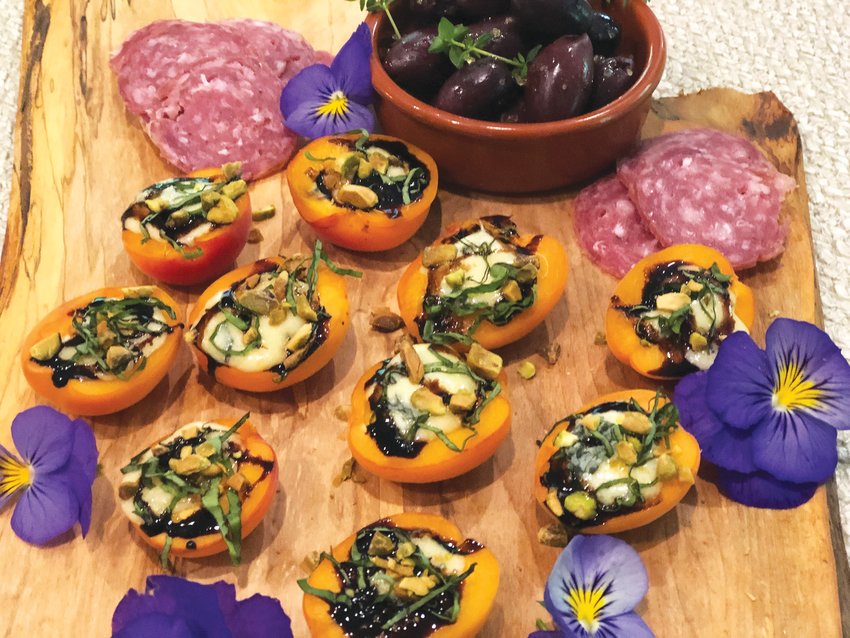 Fresh apricots stuffed with blue cheese are a sweet addition to a charcuterie board.