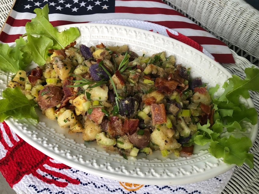 This non-mayonnaise potato salad bathes boiled red, white and blue potatoes in a bacon, white wine, cider vinegar and tarragon-laced dressing.