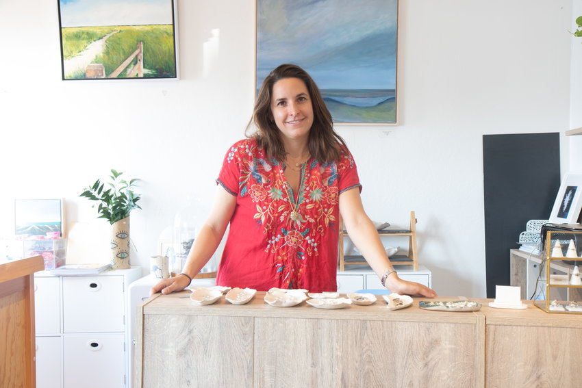 Icarus &amp; Co. co-owner Caroline Mullen in the Old South Wharf jewelry boutique she shares with watercolor painter and photographer Krys DeMauro. Mullen&rsquo;s jewelry transforms Nantucket&rsquo;s natural beauty into wearable art.