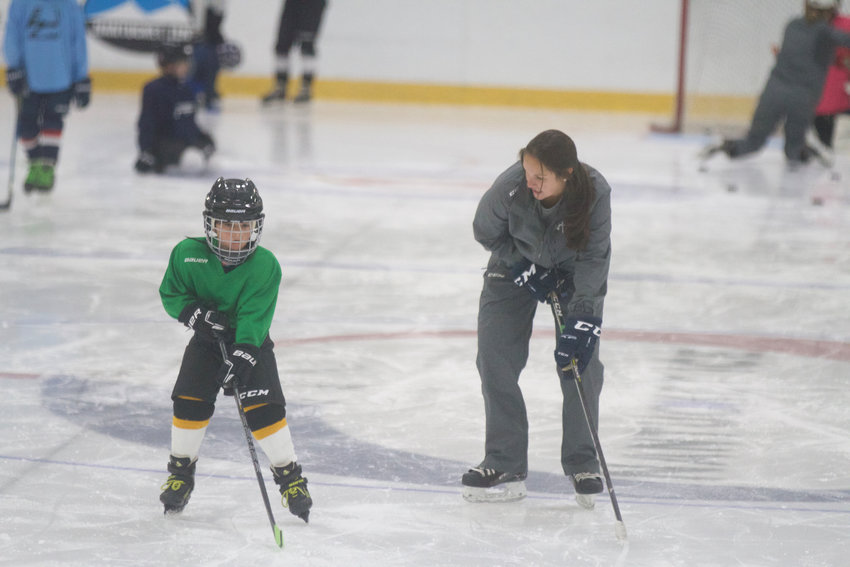 Liz Collins working with Ren Lucas on his skating during the first session of her camp