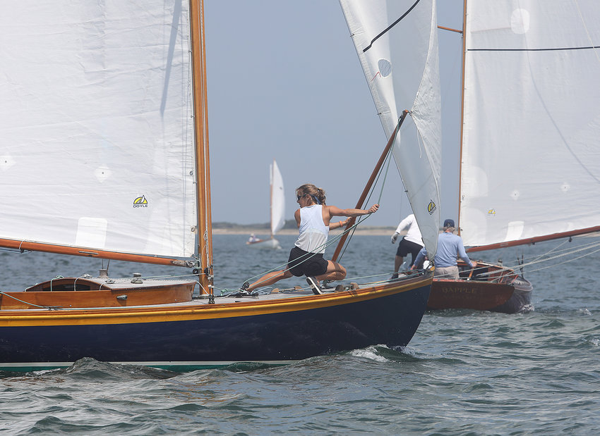 Crew member Alli Hudson holds the jib on the Alerion Rhapsody after rounding the windward mark during the One Design Regatta in Nantucket Harbor on the opening day of Race Week 2021.