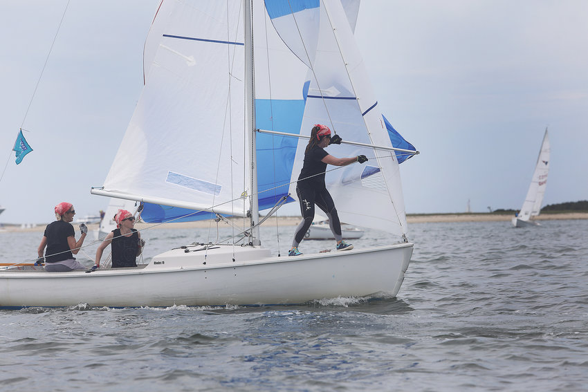 Sandy Adjick has the tiller as Hollis von Summer sets the spinnaker and Vanessa Coleman handles the lines during the 2021 Women's Regatta in the harbor on Wednesday.