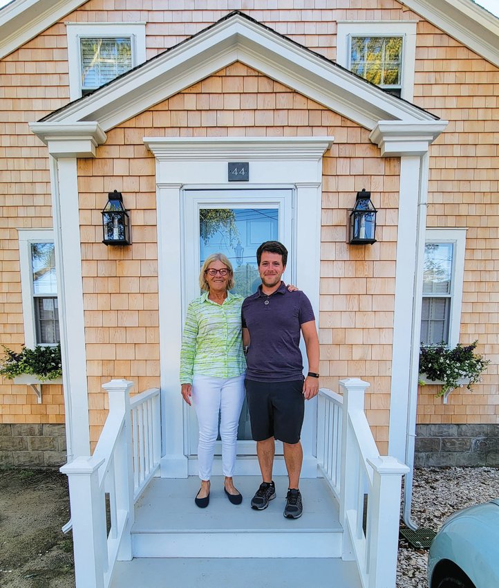 Debbie Miller and stands with Tom Peppard at the house on N. Liberty Street that Miller and her partner Carol Nast recently purchased and are now renting to Peppard and his partner Eddie Wilkin.