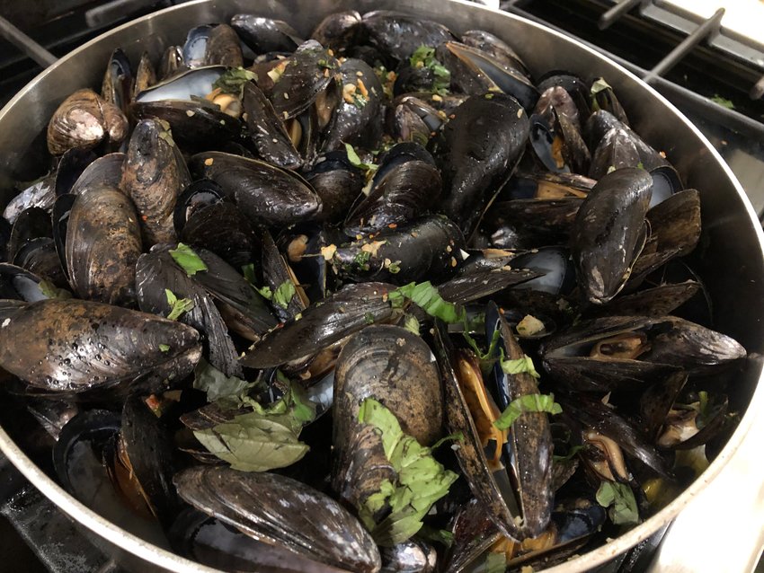 Steaming mussels with dry vermouth in a shallow skillet rather than a deep pot allows for more uniform opening of the shellfish.