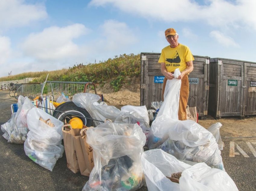 Nantucket Clean Team founder Bill Connell with some of the garbage volunteers collected around the Jetties Beach parking lot late last month; Herb Mittenthal brings a bag of trash to the collection area at Jetties; Vincenzo DiCosola uses a picker to hunt for roadside litter.
