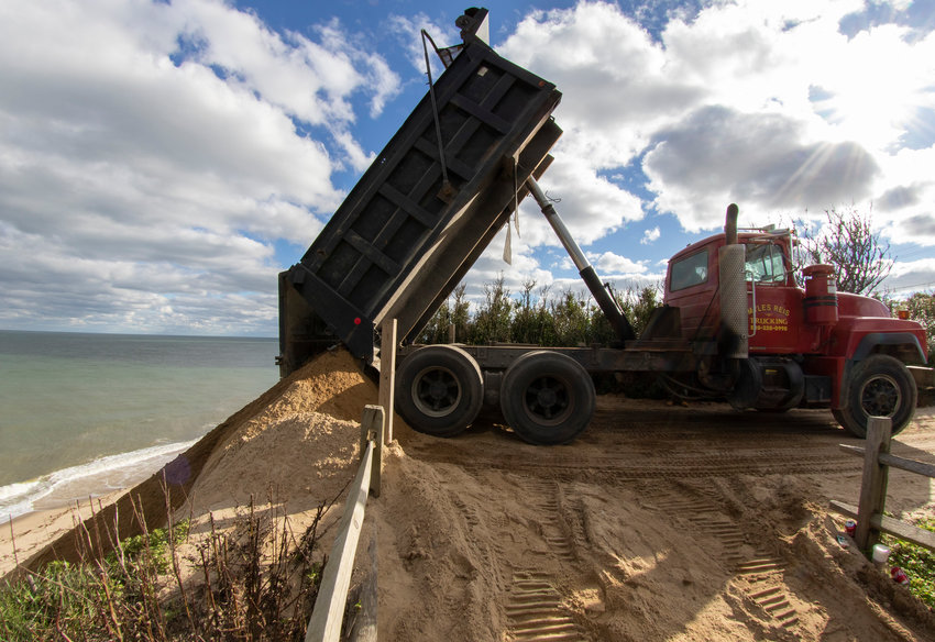 Sand being deposited over the Sankaty Bluff to cover erosion-control geotextile tubing.
