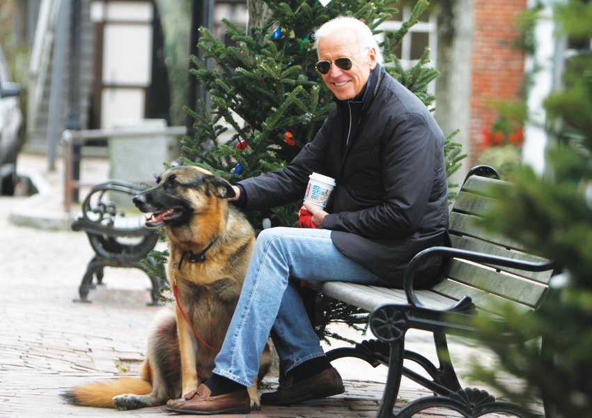 Then vice president Joe Biden relaxes on Main Street with his German shepherd Champ during his annual Thanksgiving to Nantucket in 2013.