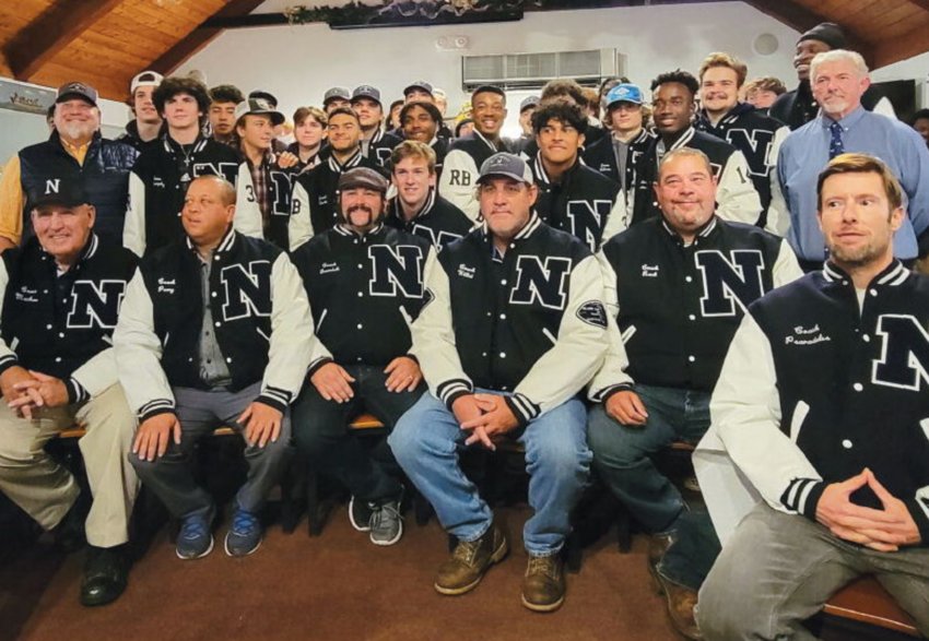 Nantucket varsity football coaches and players pose with their letterman jackets Friday at Faregrounds.