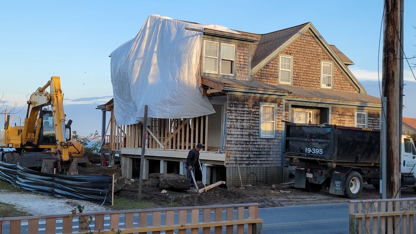 Work is underway to move this house from Land Bank-owned property at 44 Washington St. to create additional open space along Nantucket Harbor.