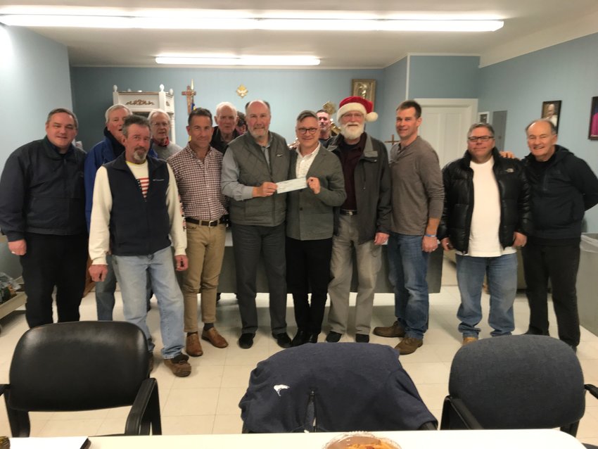 Vincent DeBaggis of the Knights of Columbus T.J. McGee Council presents a check for $17,000 to Inky Santa Toy Drive board member Kenny Hilbig.