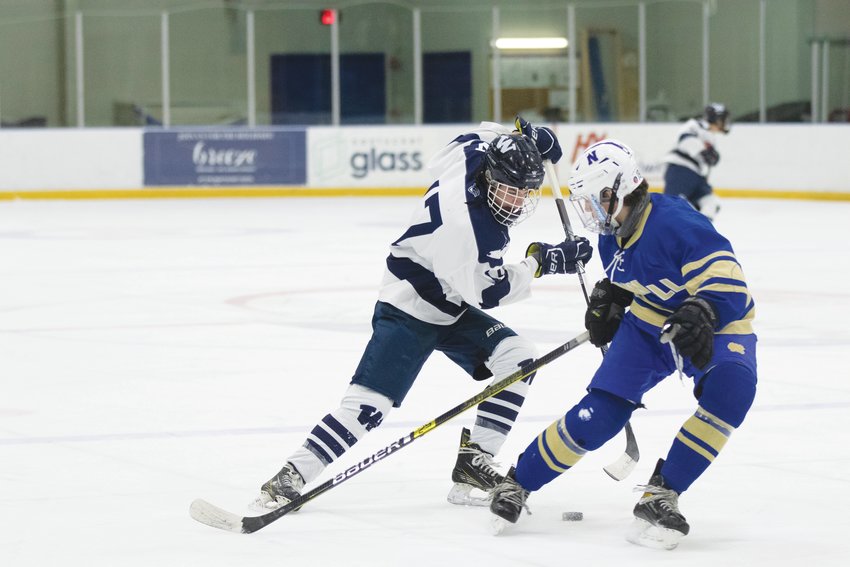 Jack Billings dekes the puck past a Norwell defender during the Whalers&rsquo; 5-0 loss at Nantucket Ice Sunday.