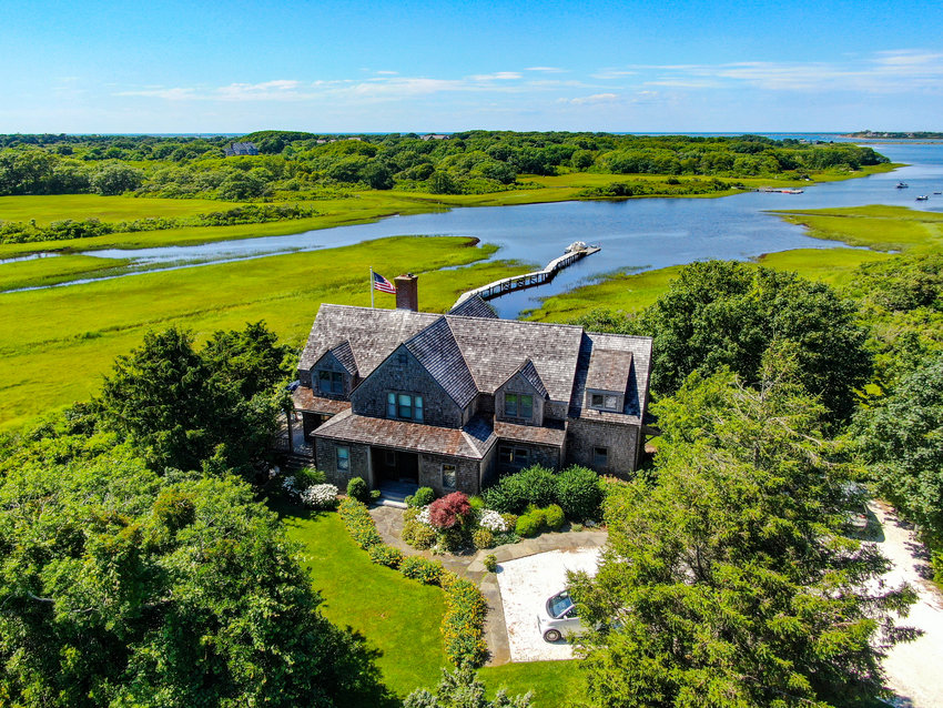 Located on 7.2 acres of picturesque land off Polpis Road bordering more than 1,000 acres of protected open space, this four-bedroom, four-and-a-half-bathroom home has pristine water views and one of only 15 licensed, privately-owned docks on the island.