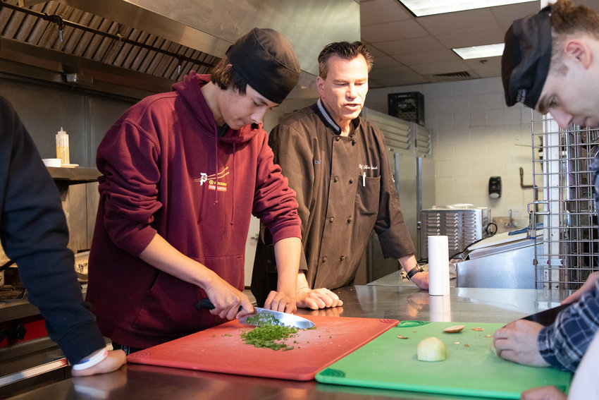 Jacob Santikulanont, chef and instructor Tom Proch and Hunter Paglia during culinary class Tuesday.