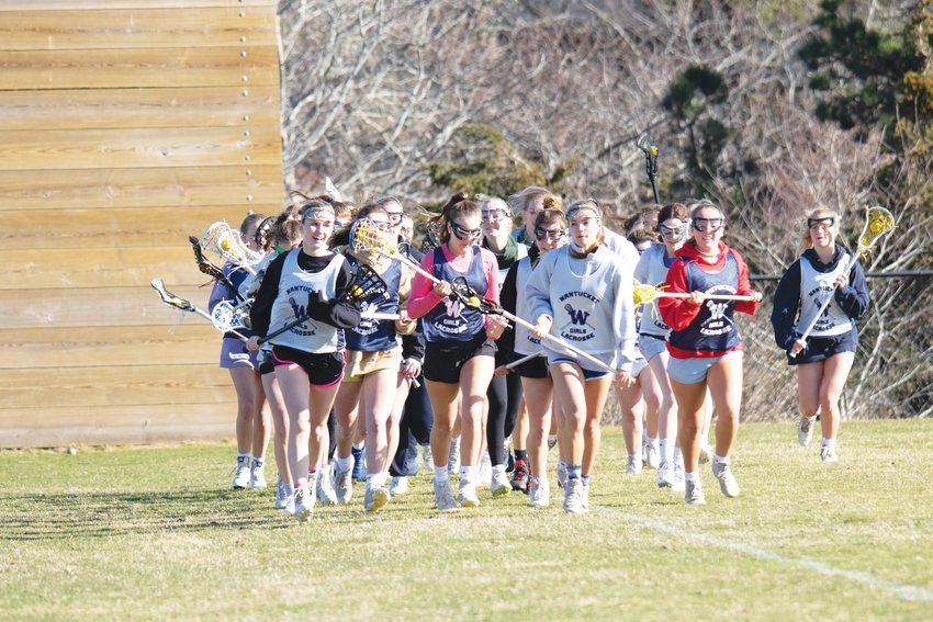 The girls lacrosse team, now 1-0 on the season, runs laps during a preseason practice last week.