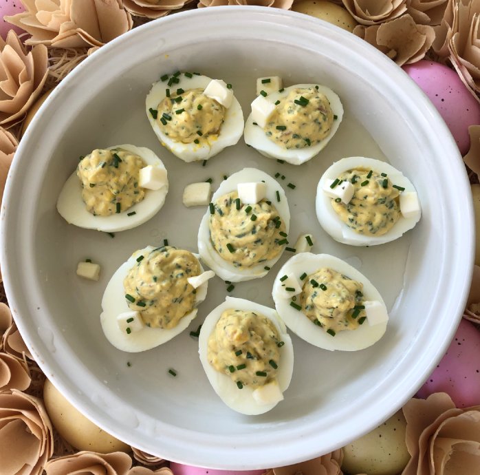 Deviled Eggs Dijonnaise are prepped and ready to be baked briefly in a hot oven.
