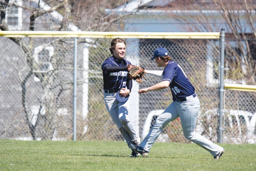 James Mack and Tim Murphy celebrate after an inning-ending catch in the outfield against Saint John Paul II Saturday.