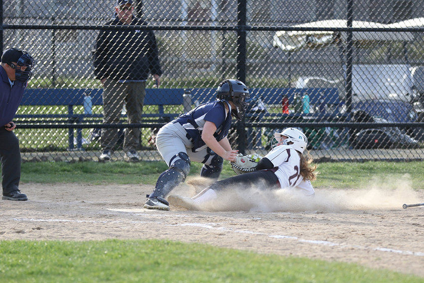 Melanie Bamber tags out a runner sliding into home.