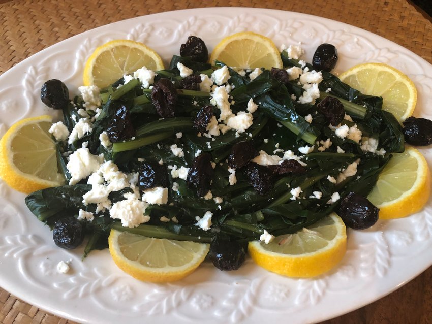 Greek Horta, boiled dandelion greens dressed with a lemony, garlicky olive-oil vinaigrette, feta cheese, kalamata olives and lemons.