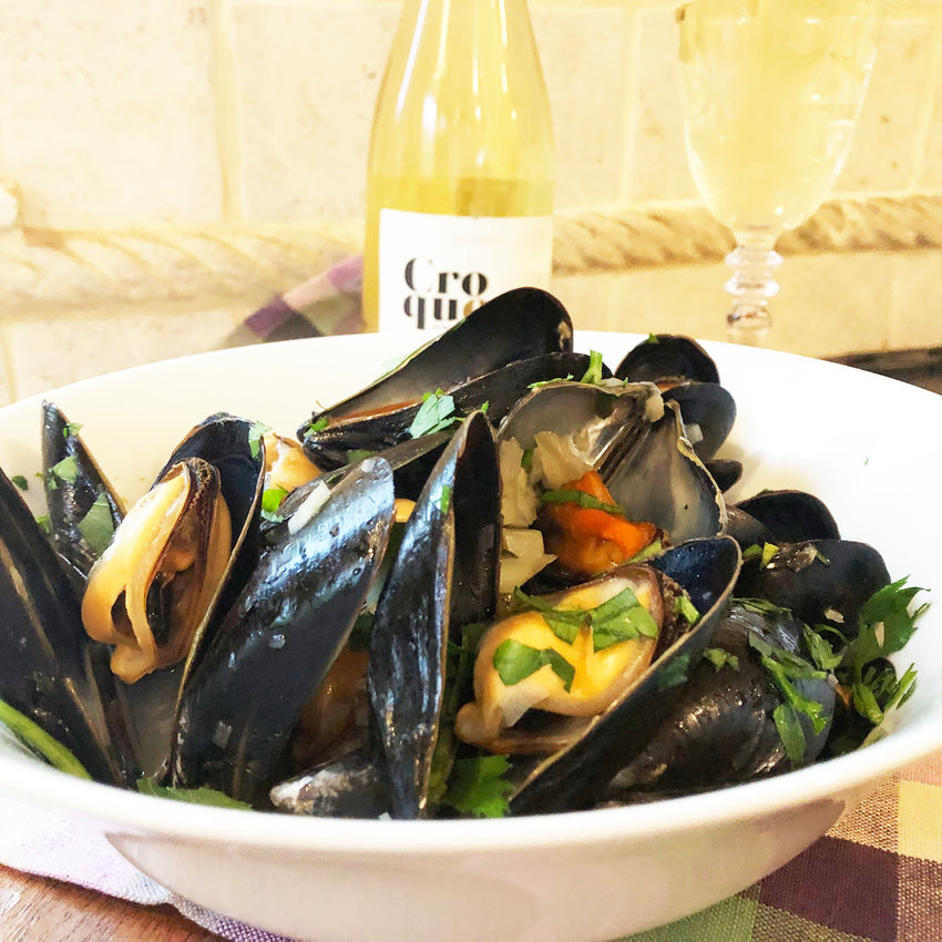These Belgian-style mussels are steamed in a white wine broth and pair wonderfully with crispy French fries.