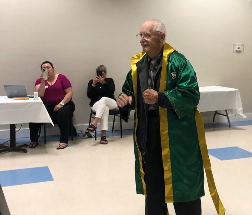 John McLaughlin, who served 52 years on the Historic District Commission, wearing the robe presented to him as a commissioner emeritus Tuesday at the Veterans of Foreign Wars hall.