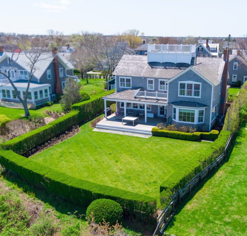 Sitting high in the Cliff Road neighborhood of prestigious Lincoln Circle, this seven-bedroom, six-and-two-half-bathroom home has picturesque views of Nantucket Harbor, Nantucket Sound and the far reaches of historic downtown.