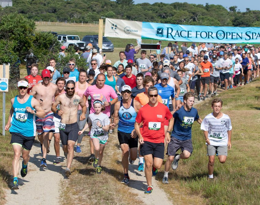 Runners take off from the start of the Nantucket Conservation Foundation&rsquo;s Race for Open Space at the Milestone Cranberry Bog in 2018.