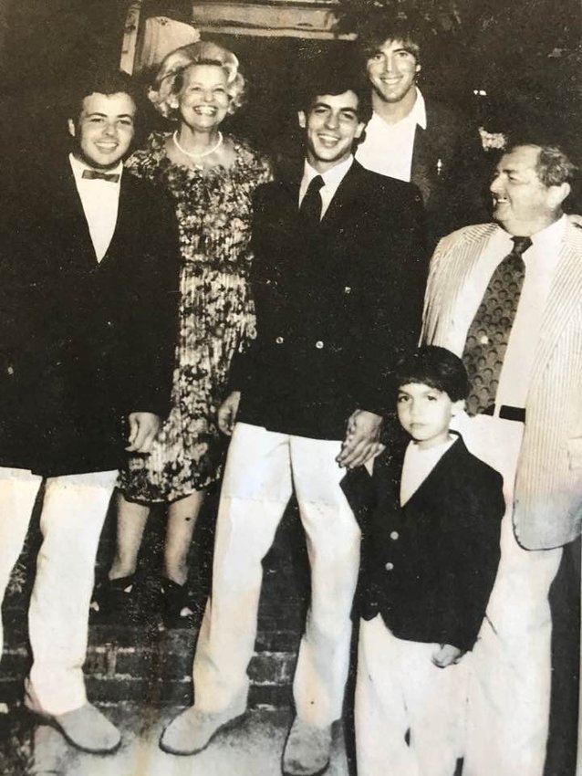 A photo of the Devine family in the early 1980s. From left are Shaun Devine, Jo Devine, Tom Devine Jr., holding his son Ethan&rsquo;s hand, Tom Devine Sr., and in the background family friend and Boston Globe photographer Stan Grossfeld.