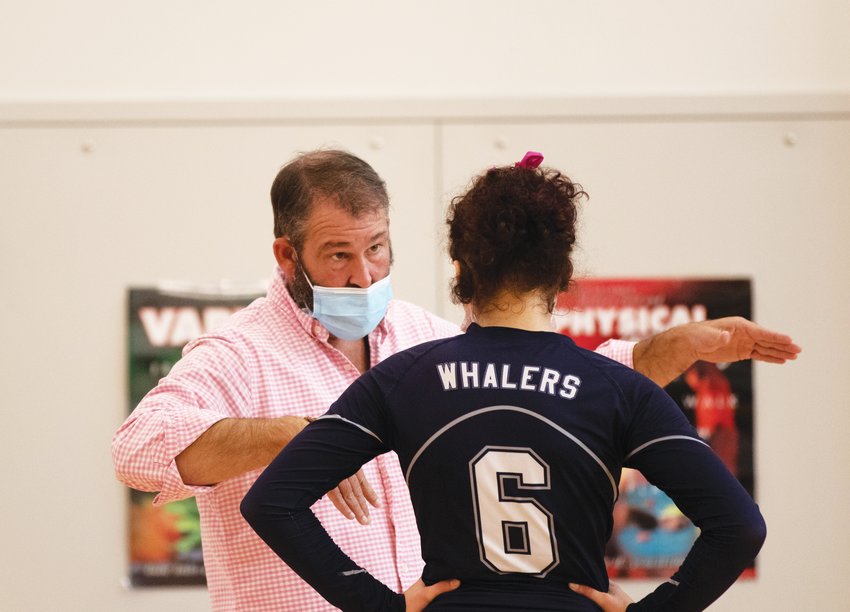 Andrew Viselli coaching up one of his players during the fall 2021 volleyball season.
