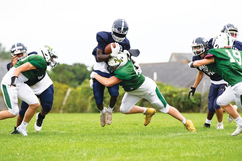 The Whalers&rsquo; defense gang-tackles a North-Reading ball-carrier during Saturday&rsquo;s home scrimmage.